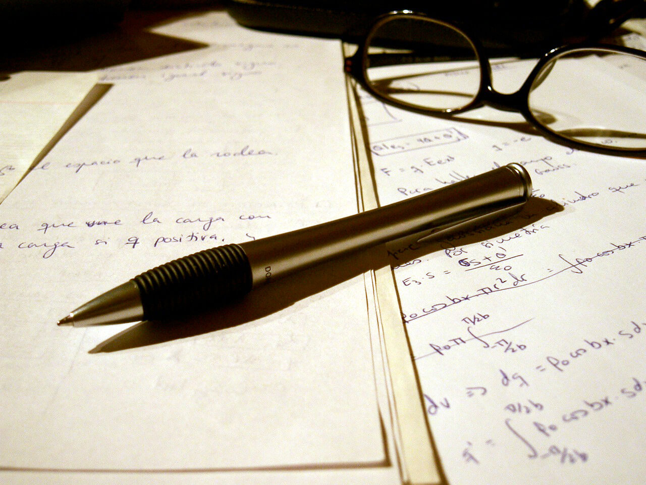 Writing a problem solution essay with a pen on a paper